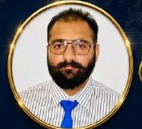 Portrait of General Manager Waqar Khadim wearing glasses and a blue tie
